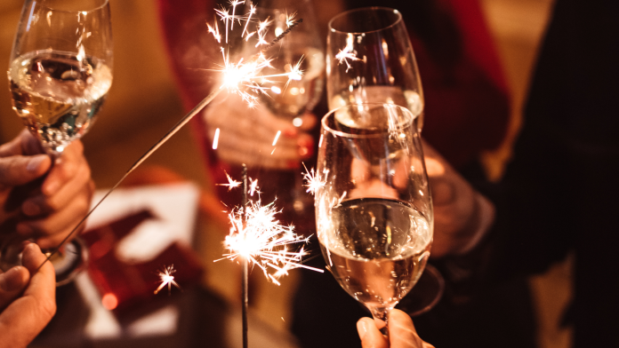 oameni ciocnesc pahare de sampanie de anul nou